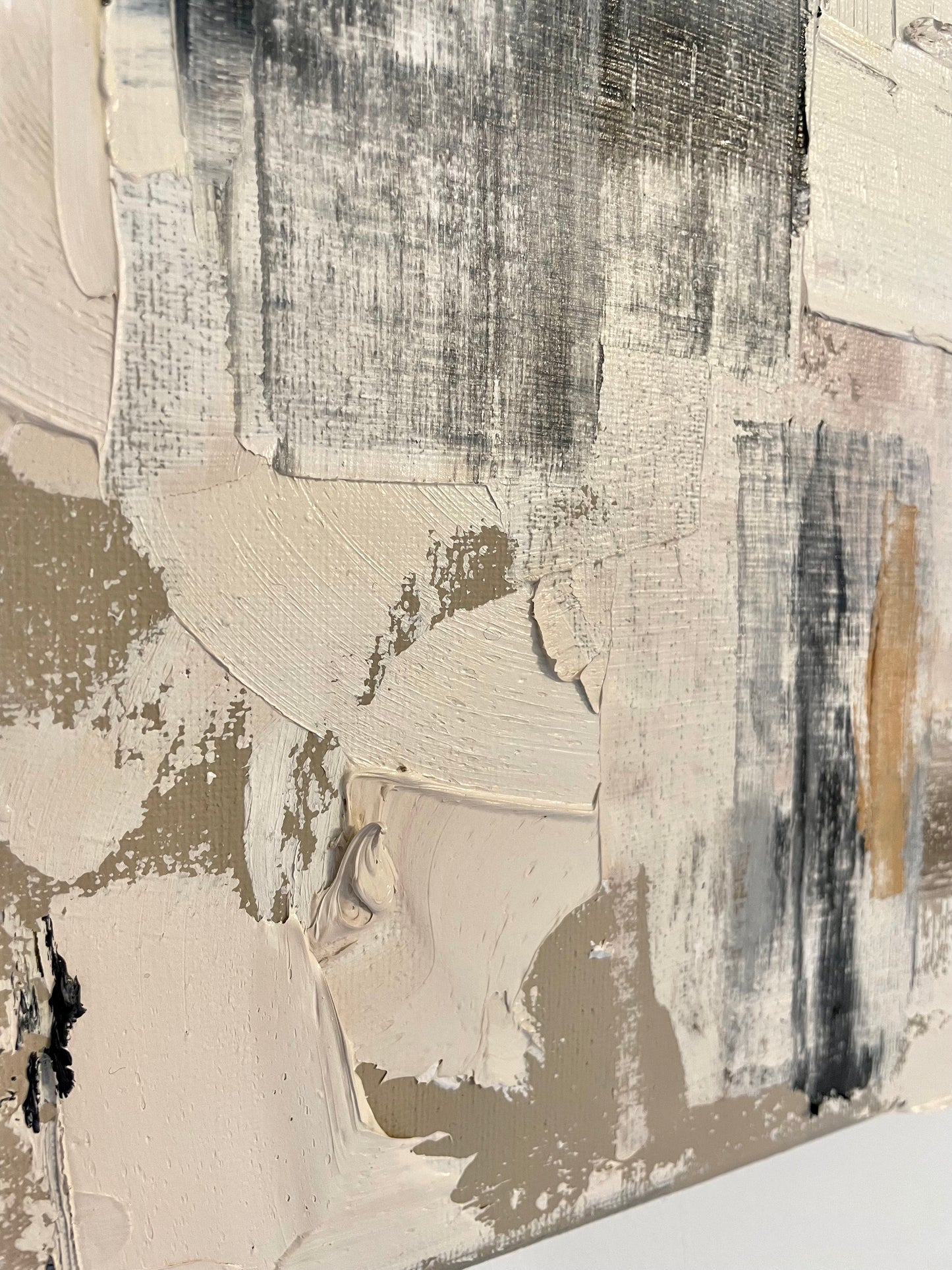 Abstract art piece with a mix of black, white, and gray brush strokes on a textured surface.