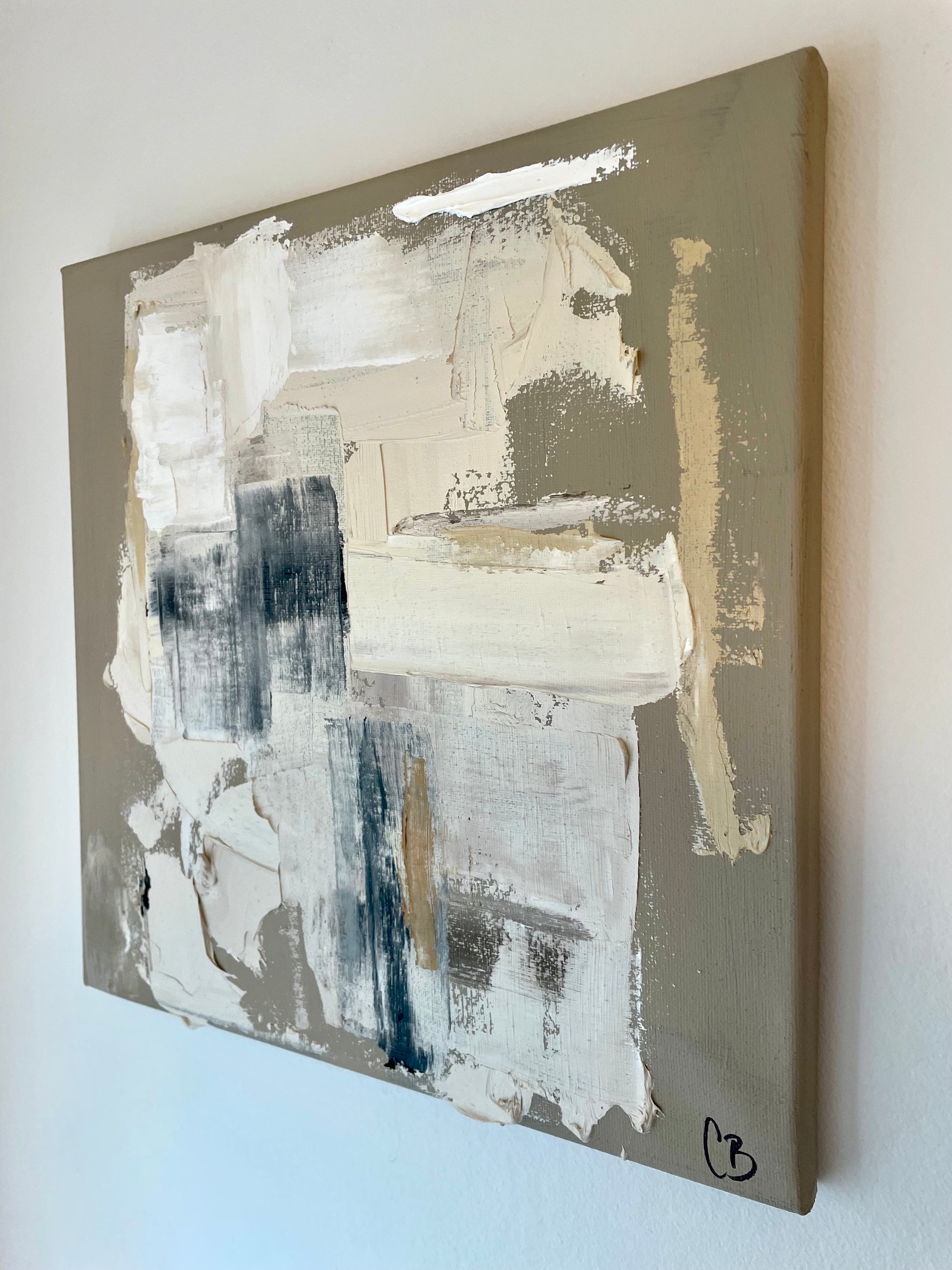 Abstract painting with beige, black, and white strokes on a gray background
