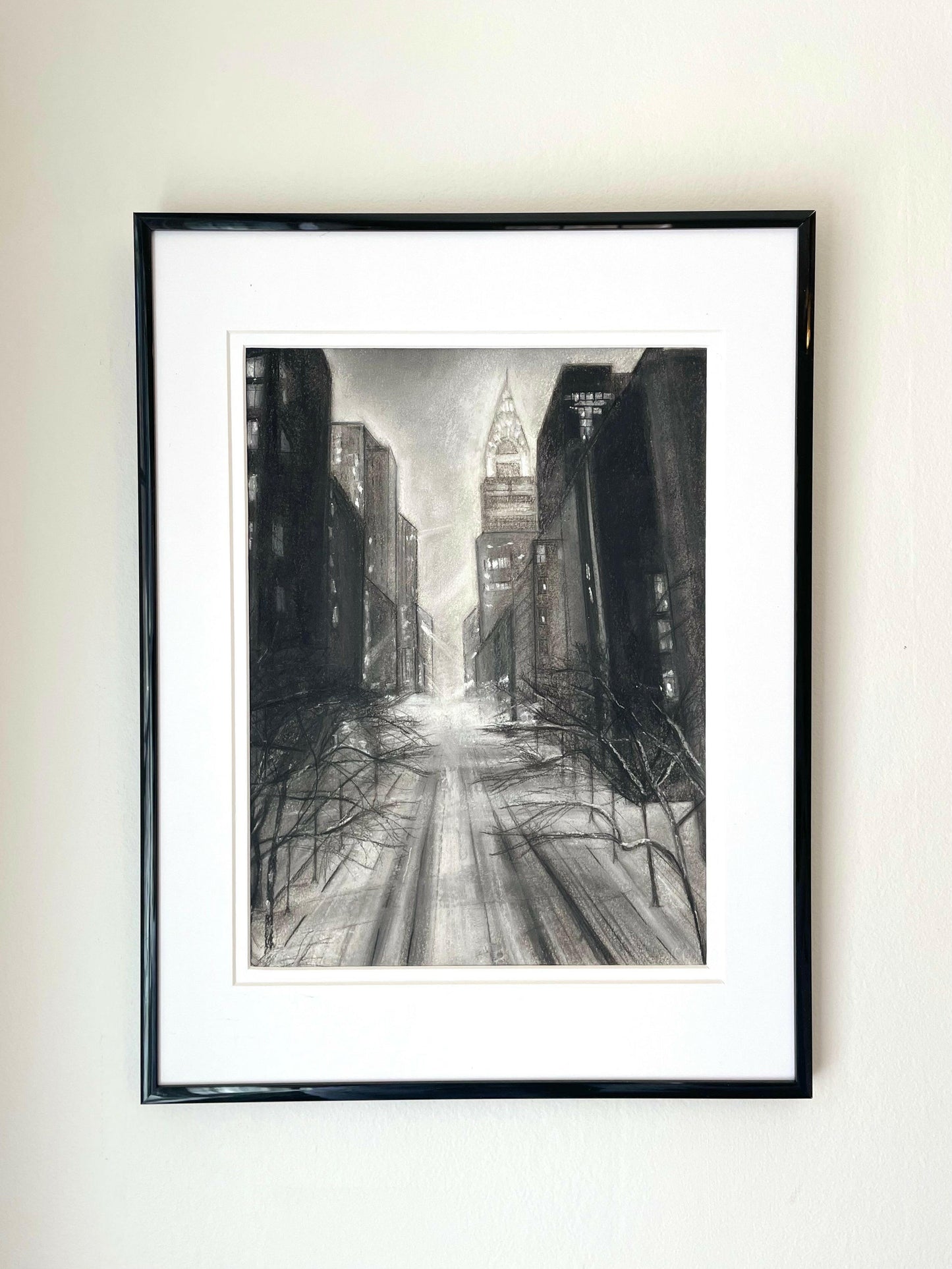 ‘New York Skyline’ – Framed charcoal drawing on paper capturing Manhattan’s iconic skyline with textured marks and architectural depth – Caroline Adrienne Art
