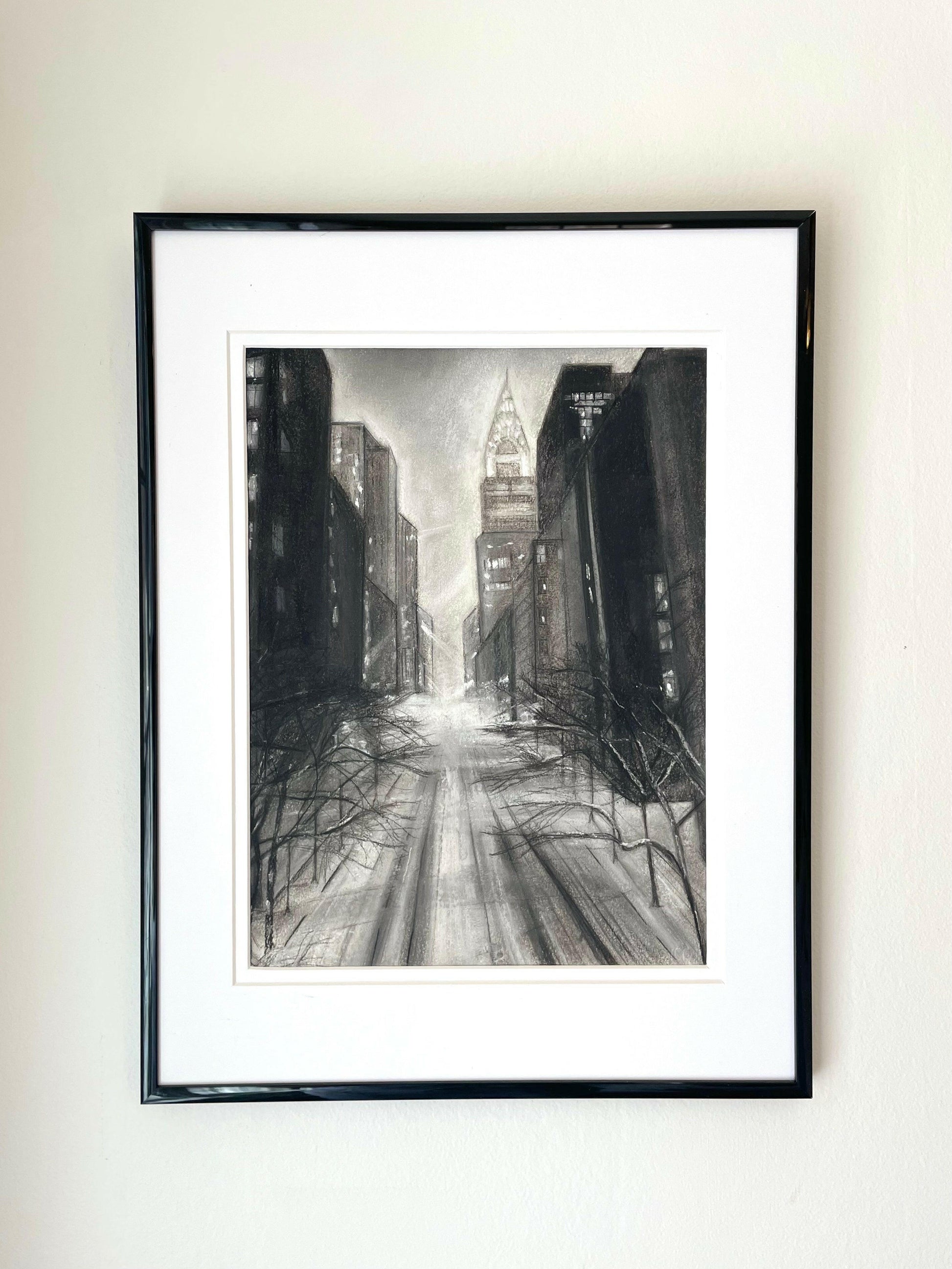 ‘New York Skyline’ – Framed charcoal drawing on paper capturing Manhattan’s iconic skyline with textured marks and architectural depth – Caroline Adrienne Art