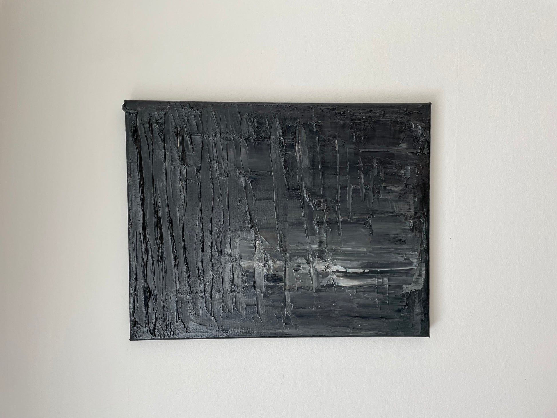 Abstract black and gray painting on a white wall