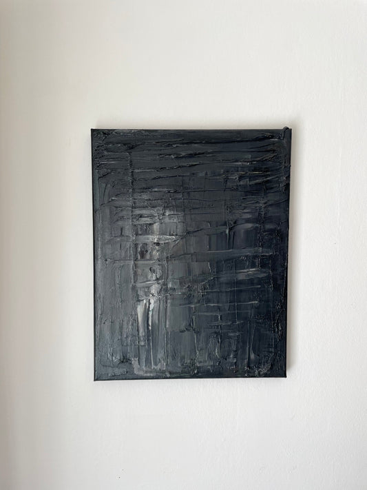 Abstract black textured painting on a white wall by Caroline Adrienne Art