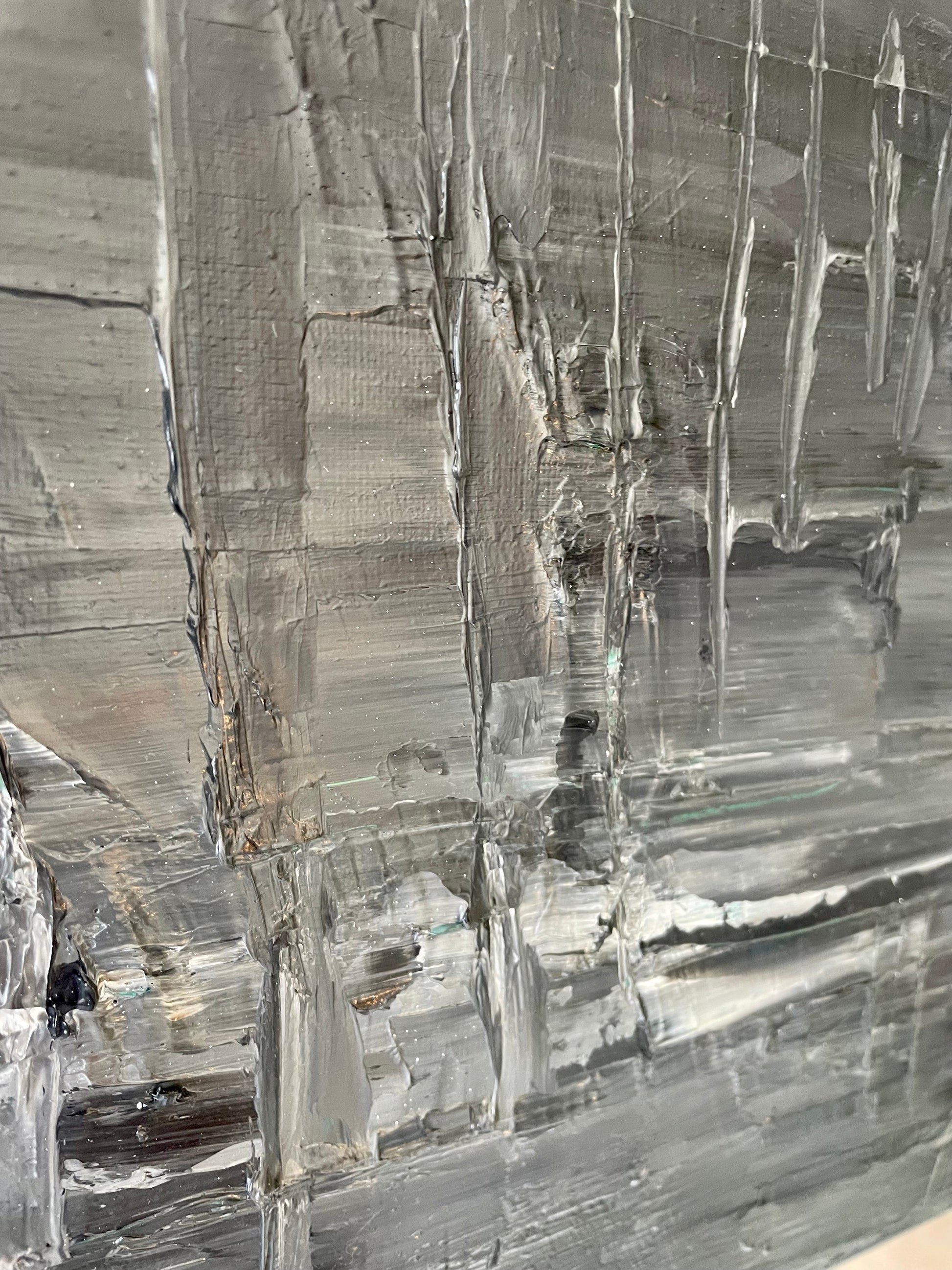 Close-up of a textured painting with reflective surface