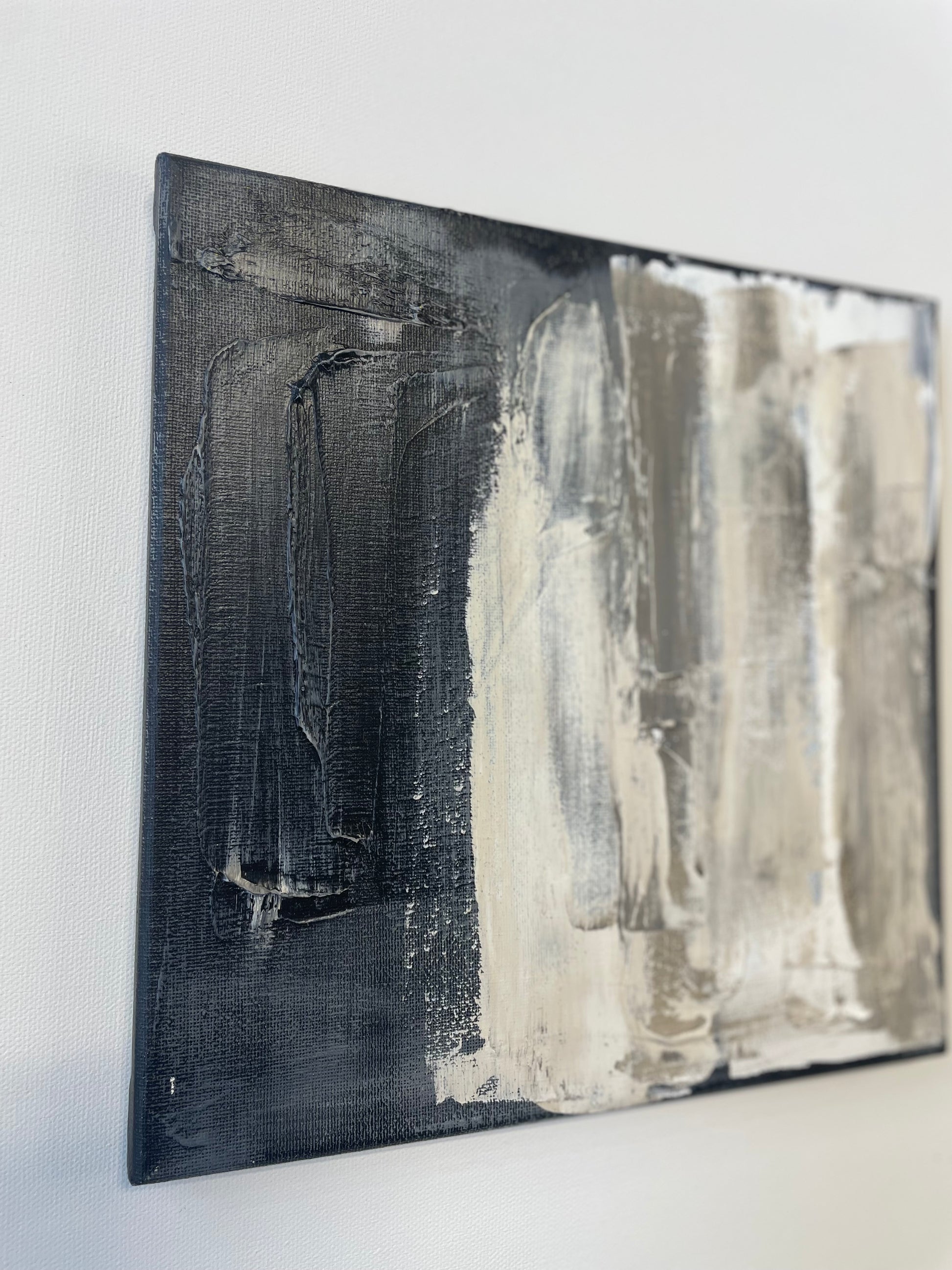 Abstract art piece with black and white brush strokes on a white background