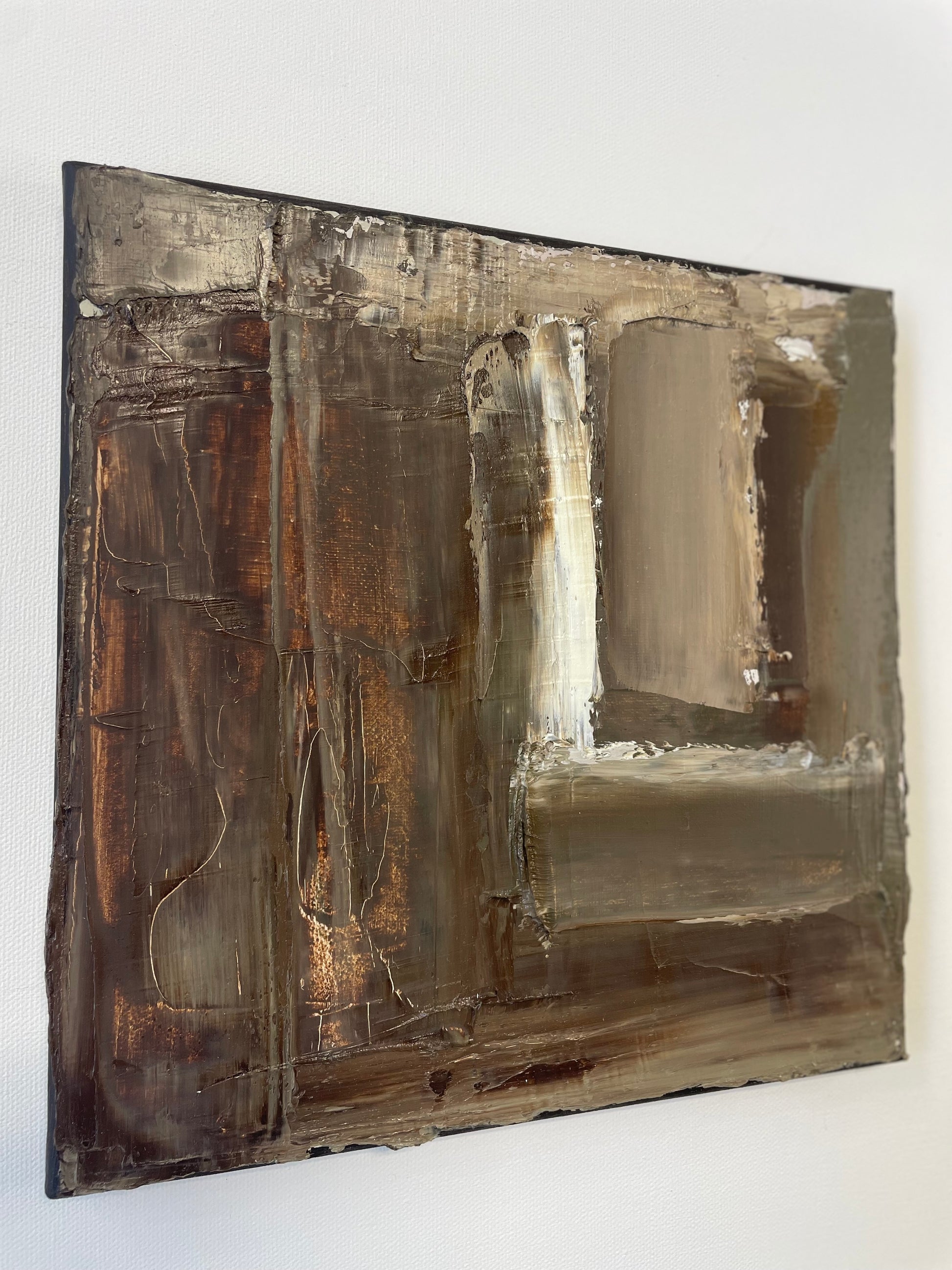 Abstract art piece with brown and beige tones on a white background