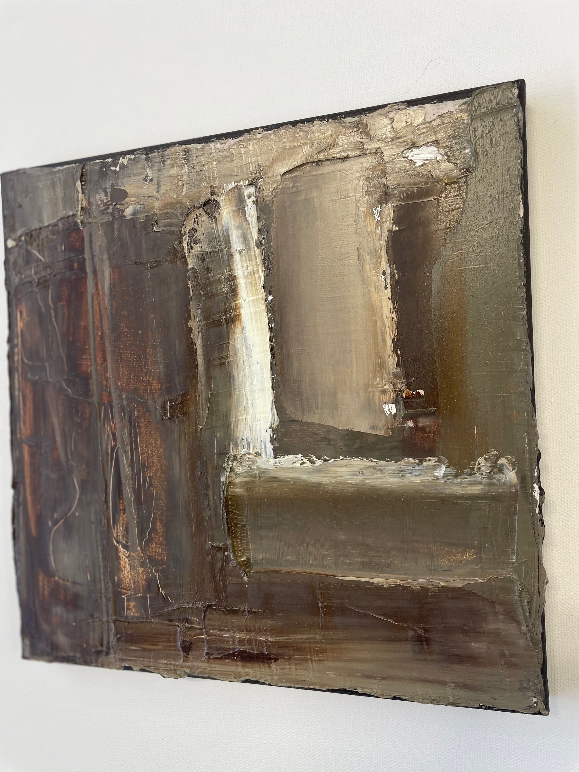 Abstract art piece with brown and beige tones on a white background