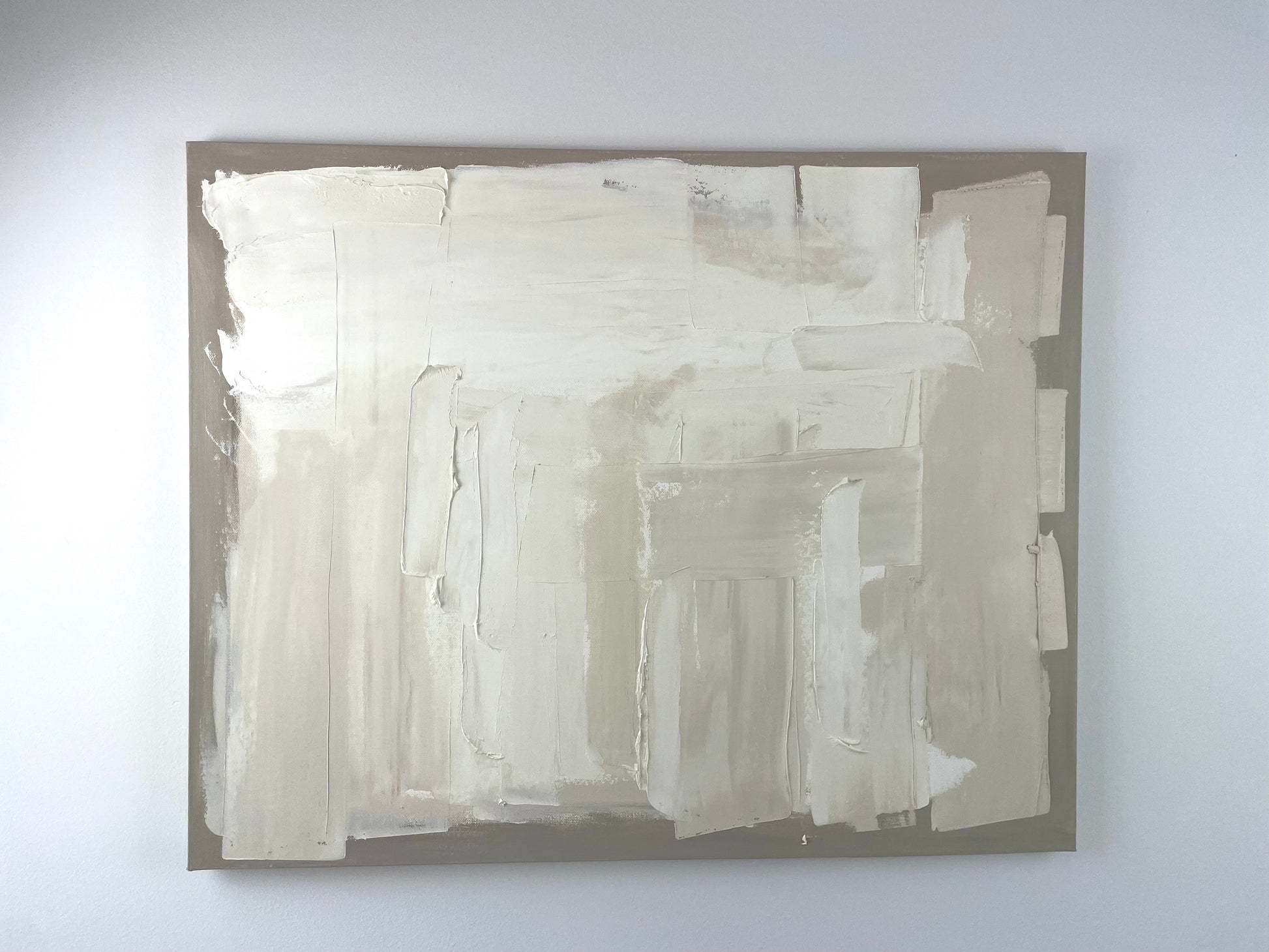 Abstract art piece on a white wall by Caroline Adrienne