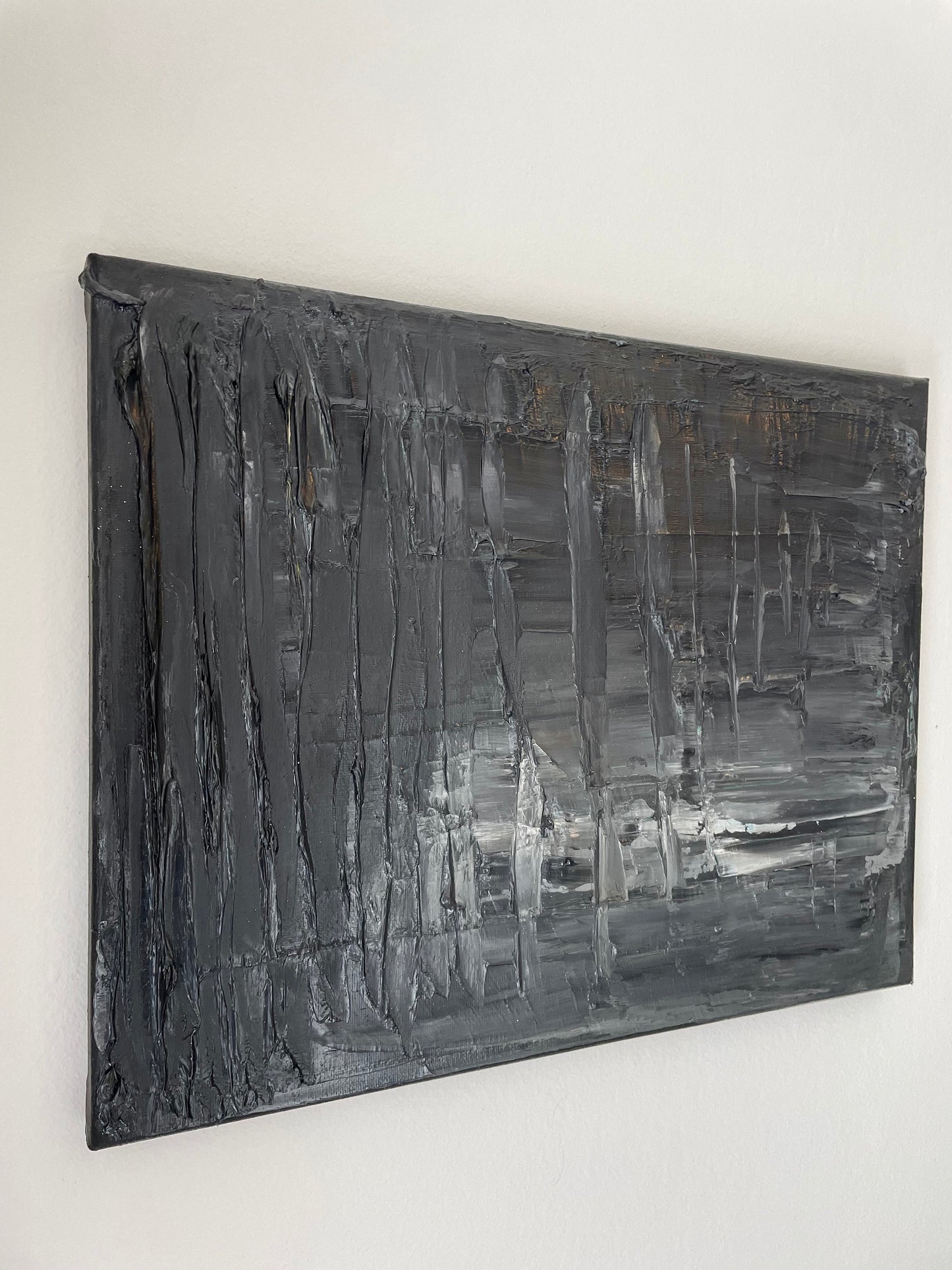 Abstract black and gray painting on a white wall