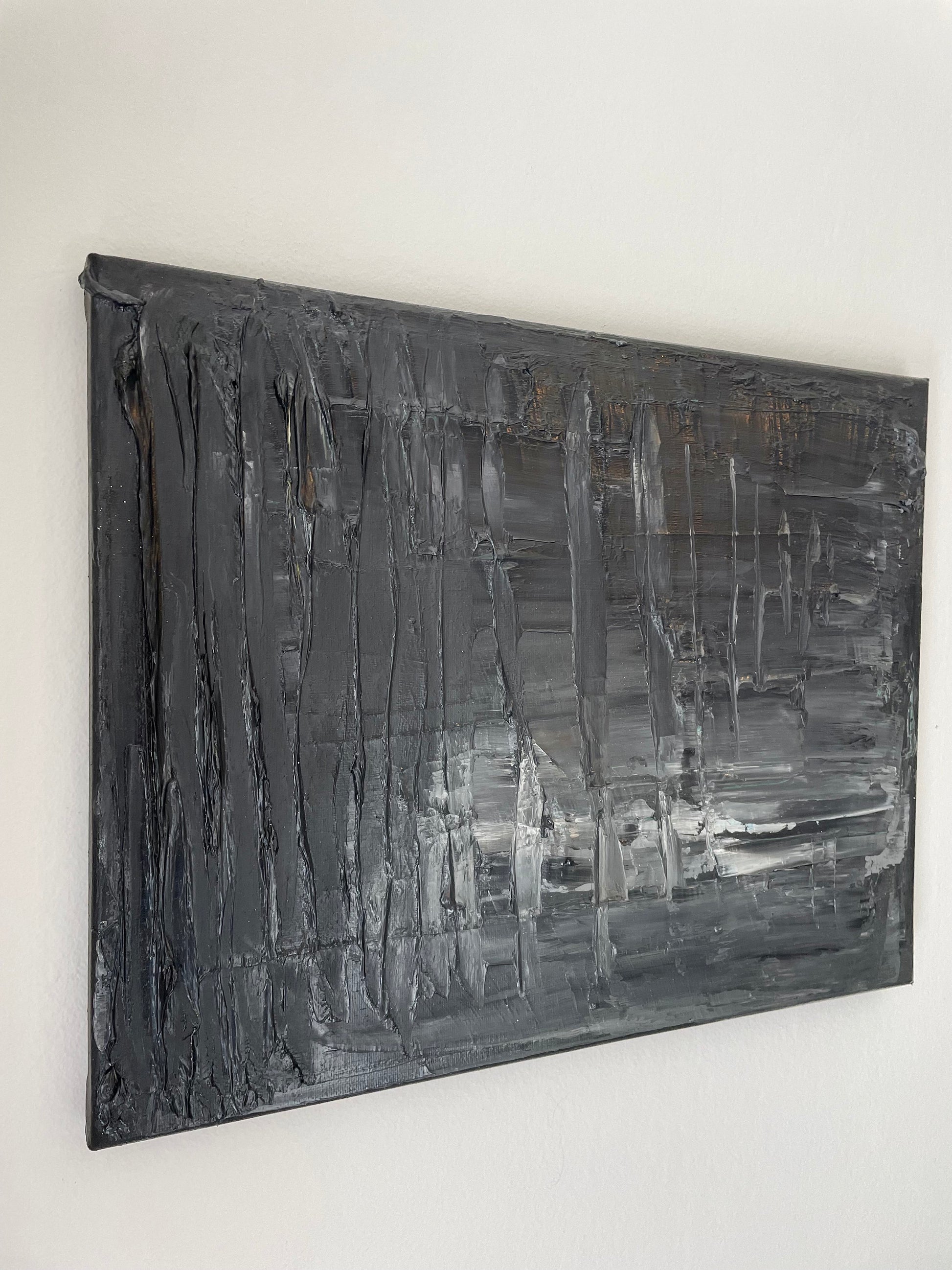 Abstract black and gray painting on a white wall