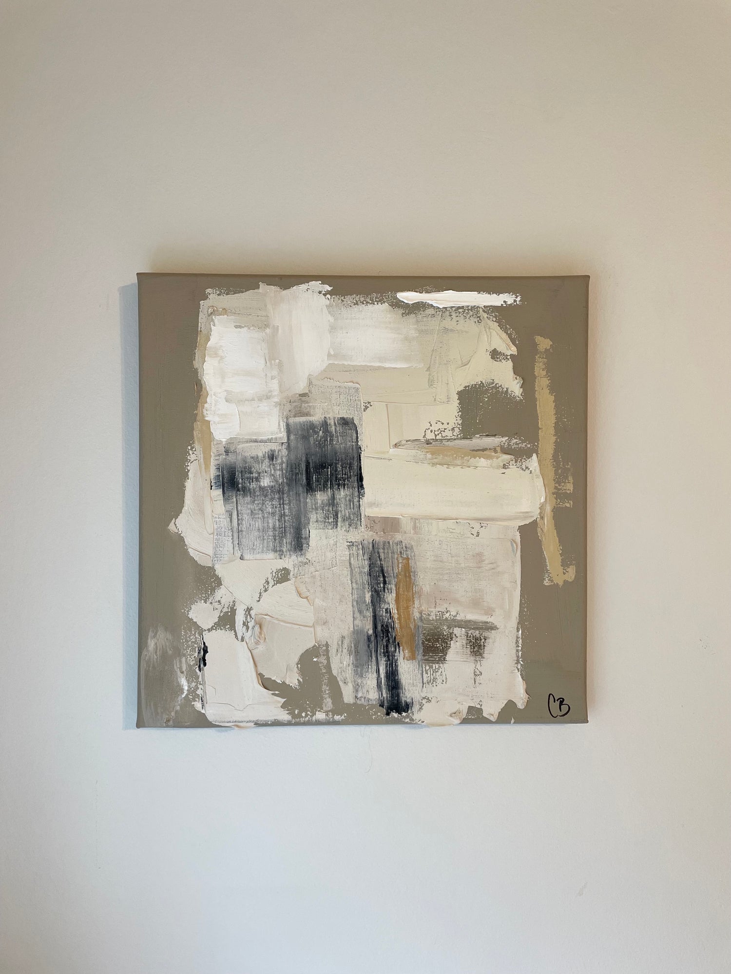 Abstract painting on a beige wall by Caroline Adrienne
