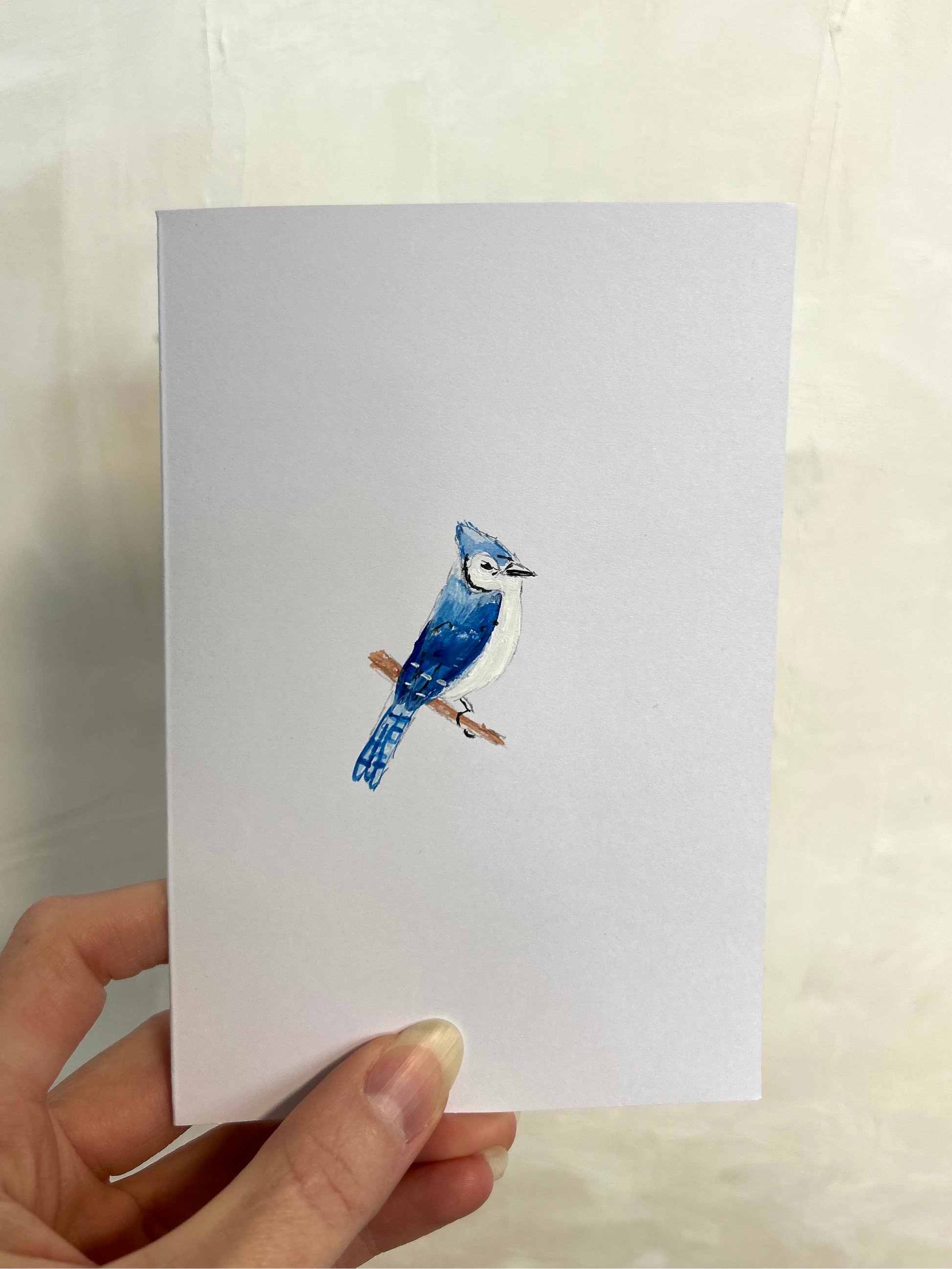 hand painted watercolor blue jay on white cardstock with plain white background
